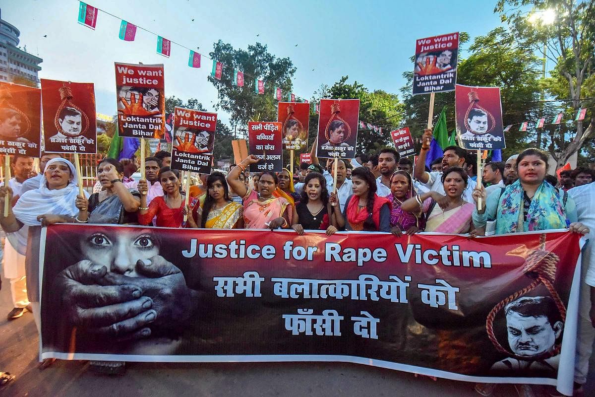 Activists take part in a candlelight march to protest against the Muzaffarpur shelter home rape case, in Patna. PTI