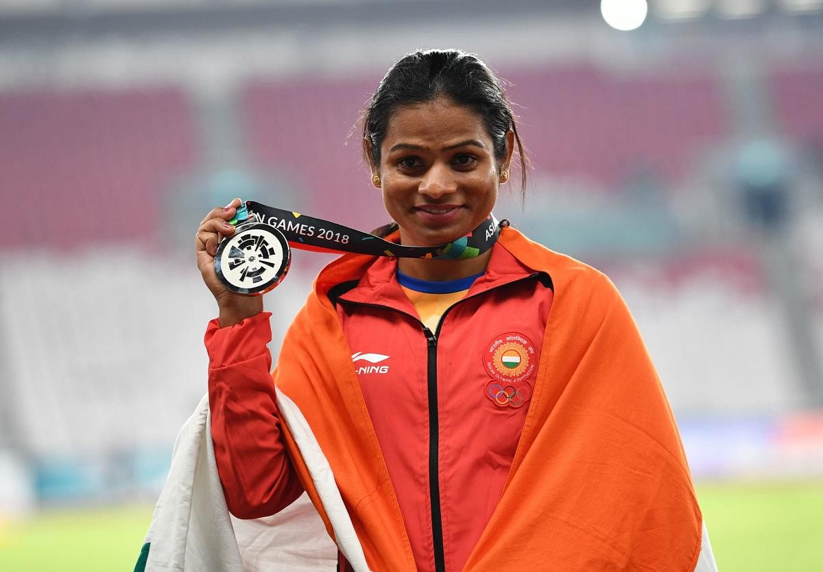 India's Dutee Chand celebrates after clinching silver in the women's 100m on Sunday. AFP