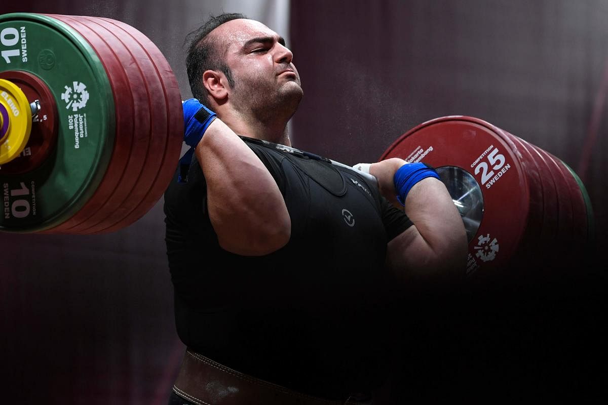 Iran's Behdad Salimikordasiabi attempts a lift during the men's snatch +105kg weightlifting group 'A' event. AFP