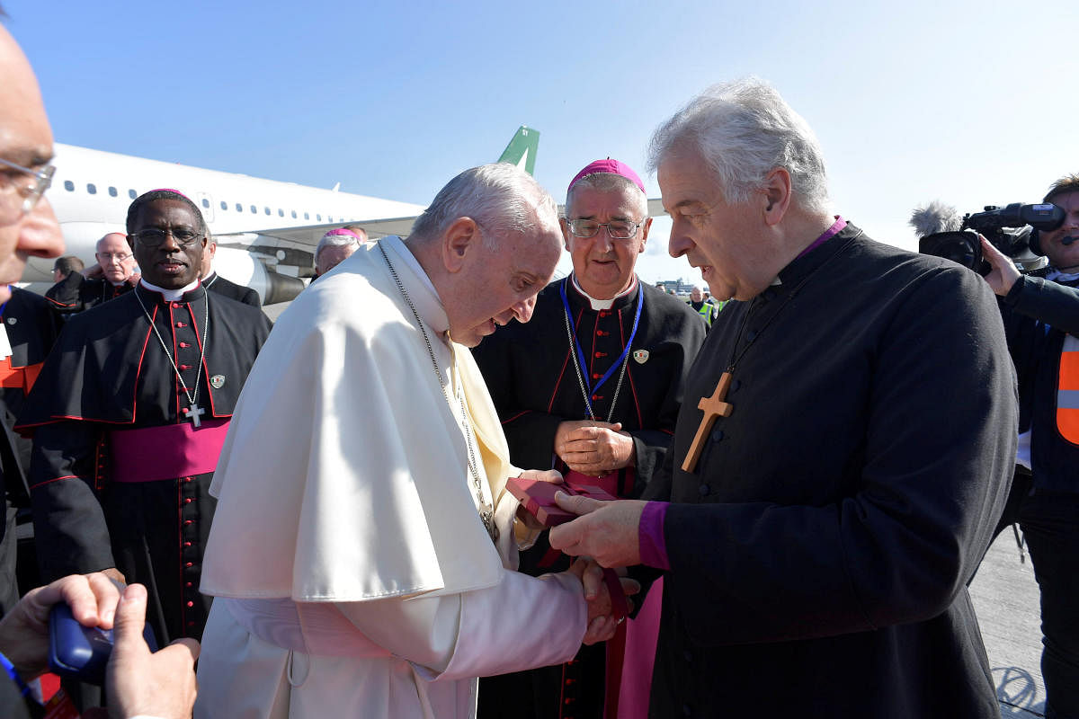 Pope Francis is welcomed by Dublin's Archbishop Diarmuid Martin (2R) upon arriving in Dublin, Ireland August 25, 2018. Picture taken August 25, 2018. (Vatican Media/Handout via REUTERS)