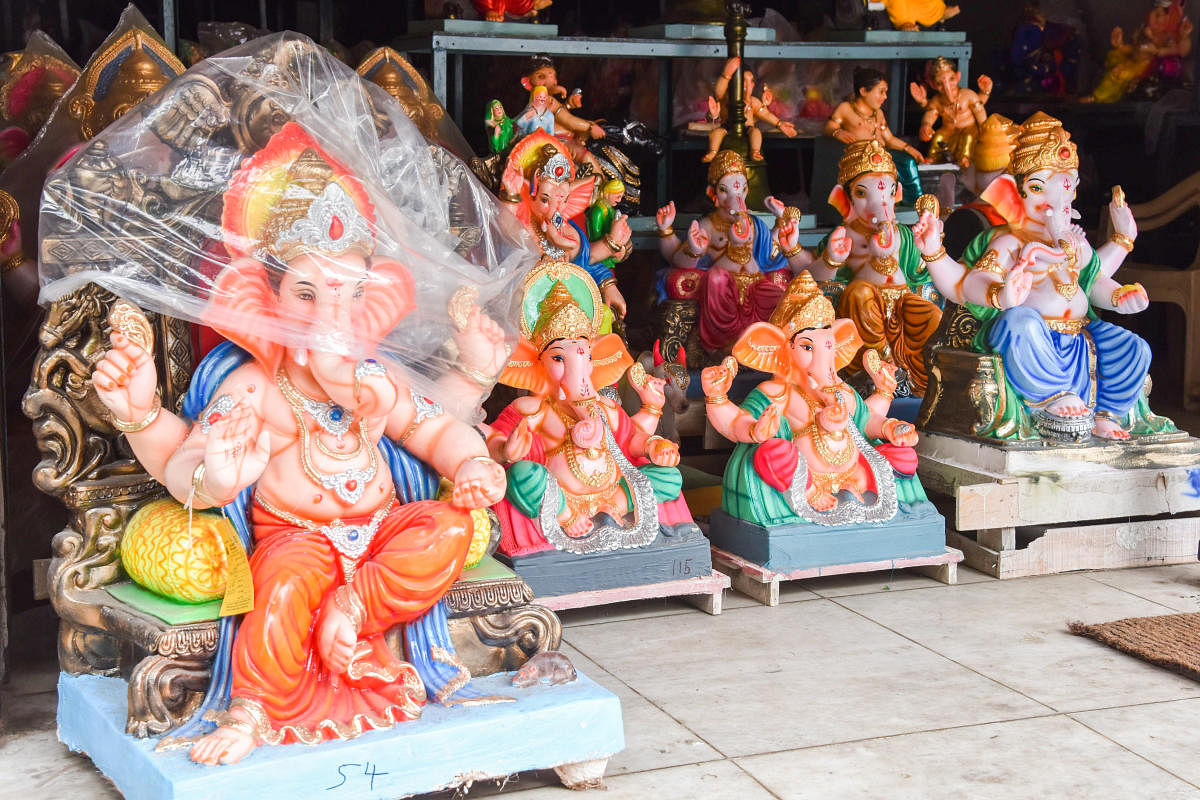 Mud Ganesha idols are placed for sale for coming Ganesha festival at RV Road in Bengaluru on Monday. Photo by S K Dinesh