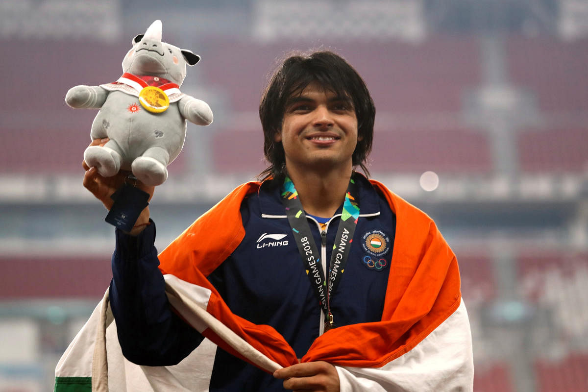 Neeraj Chopra flashes a smile after receiving the javelin throw gold at the Asian Games on Monday. REUTERS