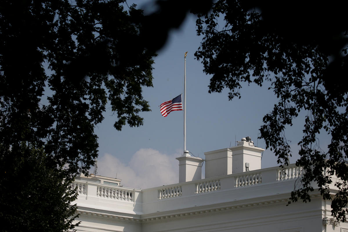 The White House flag is seen after being returned to half-staff in honor of Senator John McCain (R-AZ) after first being lowered on Sunday in his honor, then raised again just after midnight on Monday and then being returned to half-staff Monday afternoon at the White House in Washington, August 27, 2018. (REUTERS)