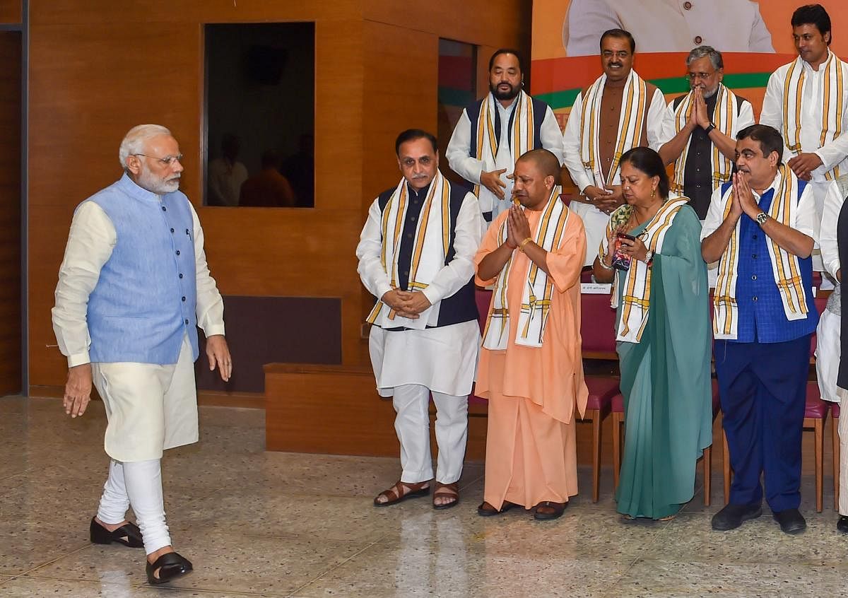 Prime Minister Narendra Modi being greeted on his arrival for a group photo before the start of a day-long meeting of the BJP Chief Ministers' Council in New Delhi on Tuesday. PTI