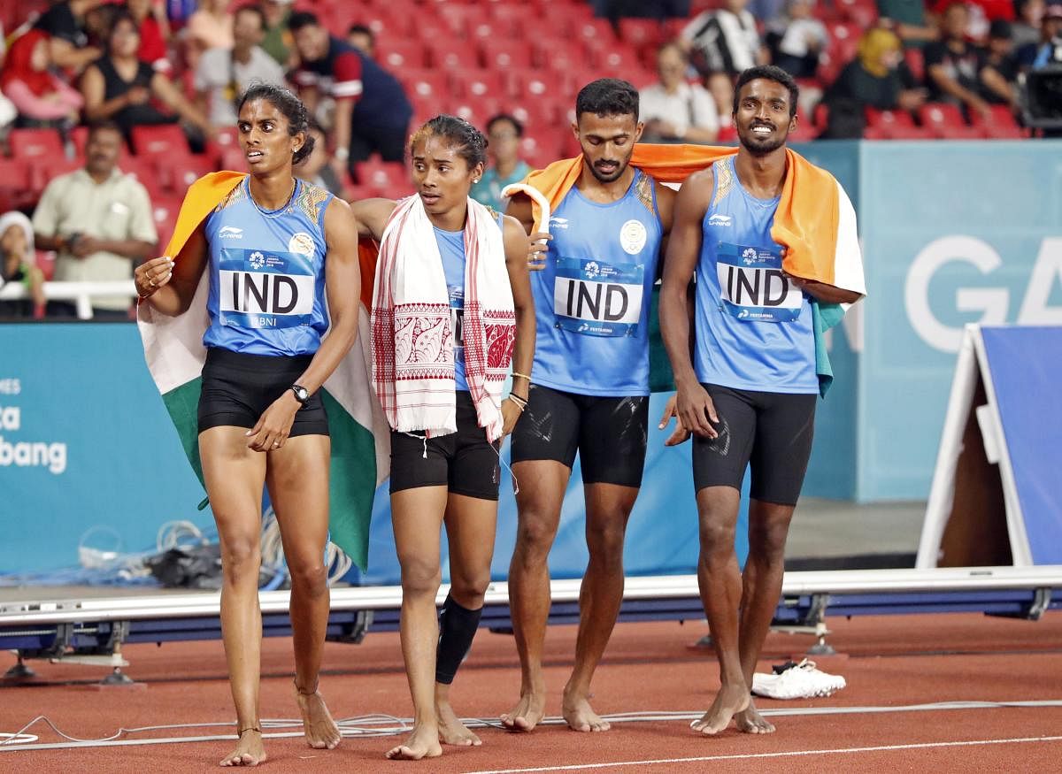 MR Poovamma, Hima Das, Muhammed Anas and Arokia Rajiv (from left) of India celebrate after finishing second in the mixed 4x400M relay in Jakarta on Tuesday. Reuters