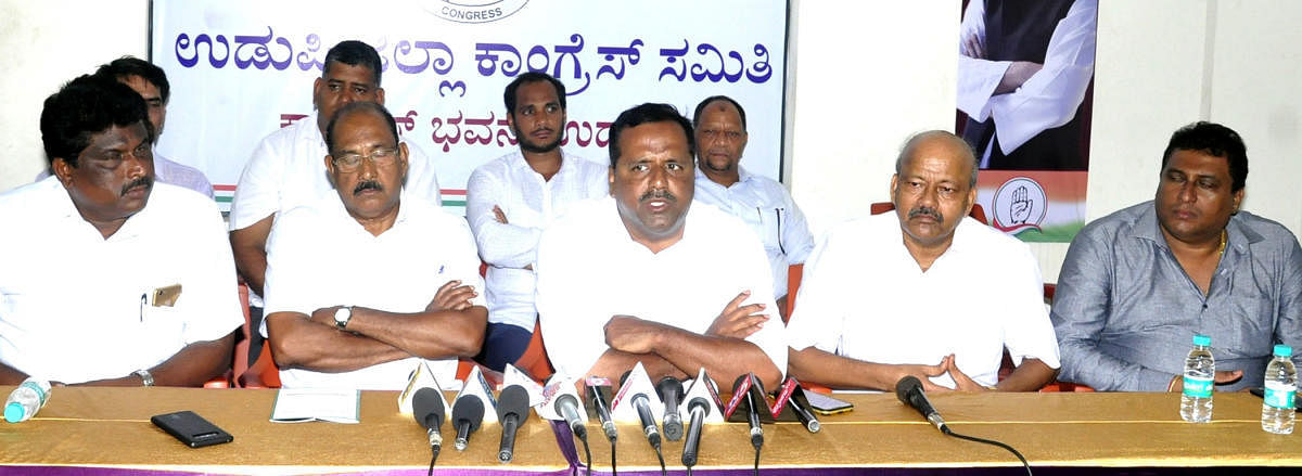 Urban Development Minister U T Khader speaks to reporters in Udupi on Tuesday.