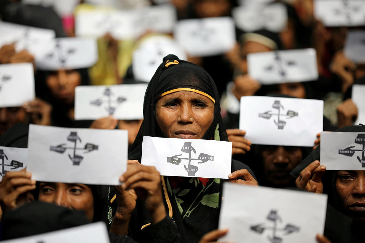 Rohingya refugee women hold placards as they take part in a protest at the Kutupalong refugee camp to mark the one-year anniversary of their exodus in Cox's Bazar, Bangladesh. Reuters File Photo