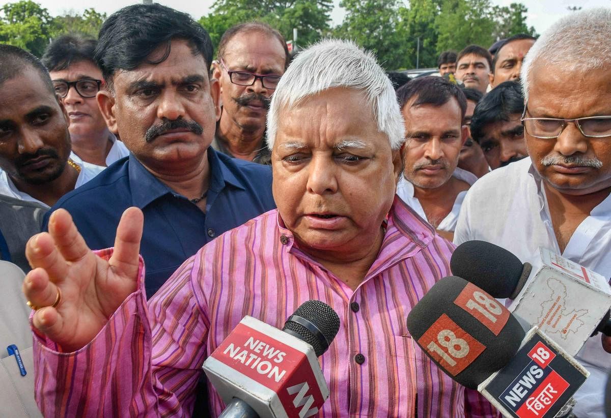 Rashtriya Janata Dal (RJD) Chief Lalu Prasad Yadav talks to the media as he leaves for Ranchi after the expiry of his granted bail, in Patna. PTI Photo
