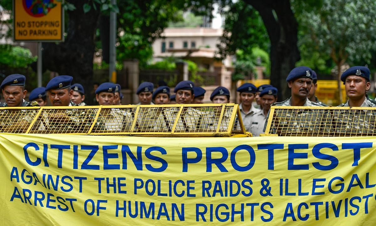 Delhi Police personnel stand on duty as activists from various organisations stage a protest pertaining to the arrest of five activists, in connection with the Bhima-Koregaon protests, in New Delhi. PTI Photo