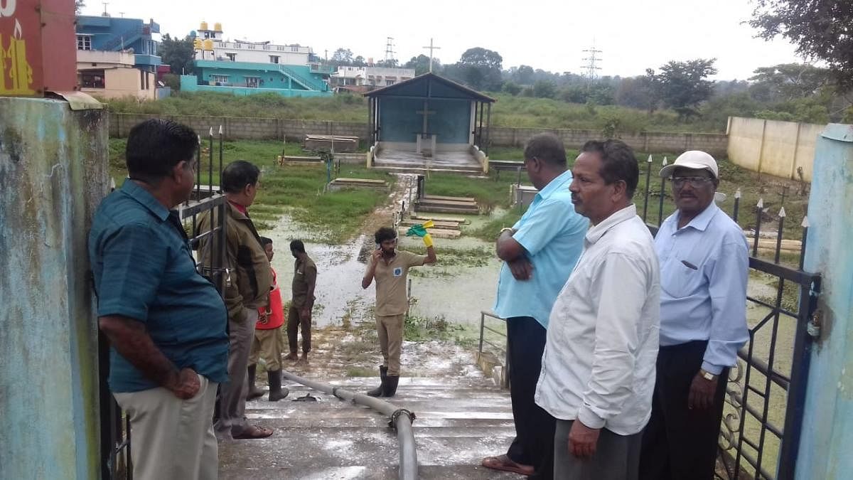 Water being drained out of a burial place at Shantidhama in Kushalnagar.
