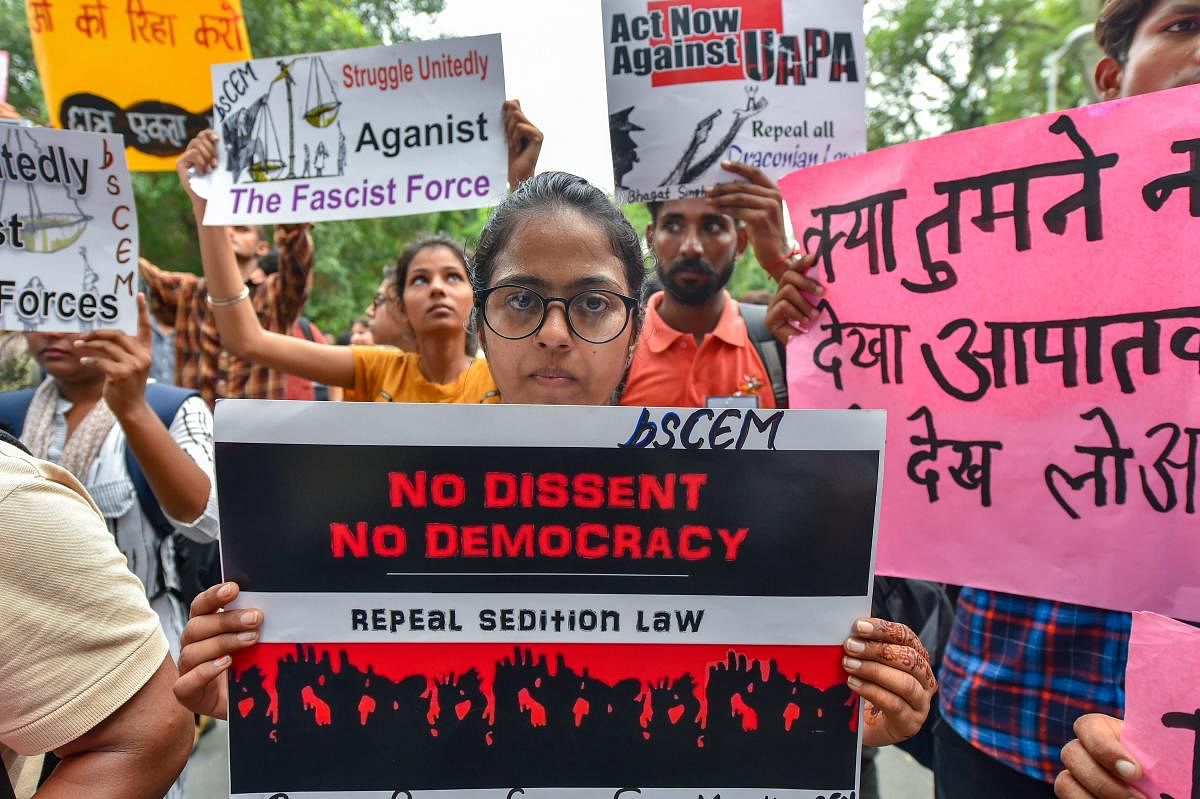 Activists of Jan Ekta Jan Adhikar Andolan' display placards during a protest against the arrests of activists and alleged state repression, in New Delhi on Thursday. PTI