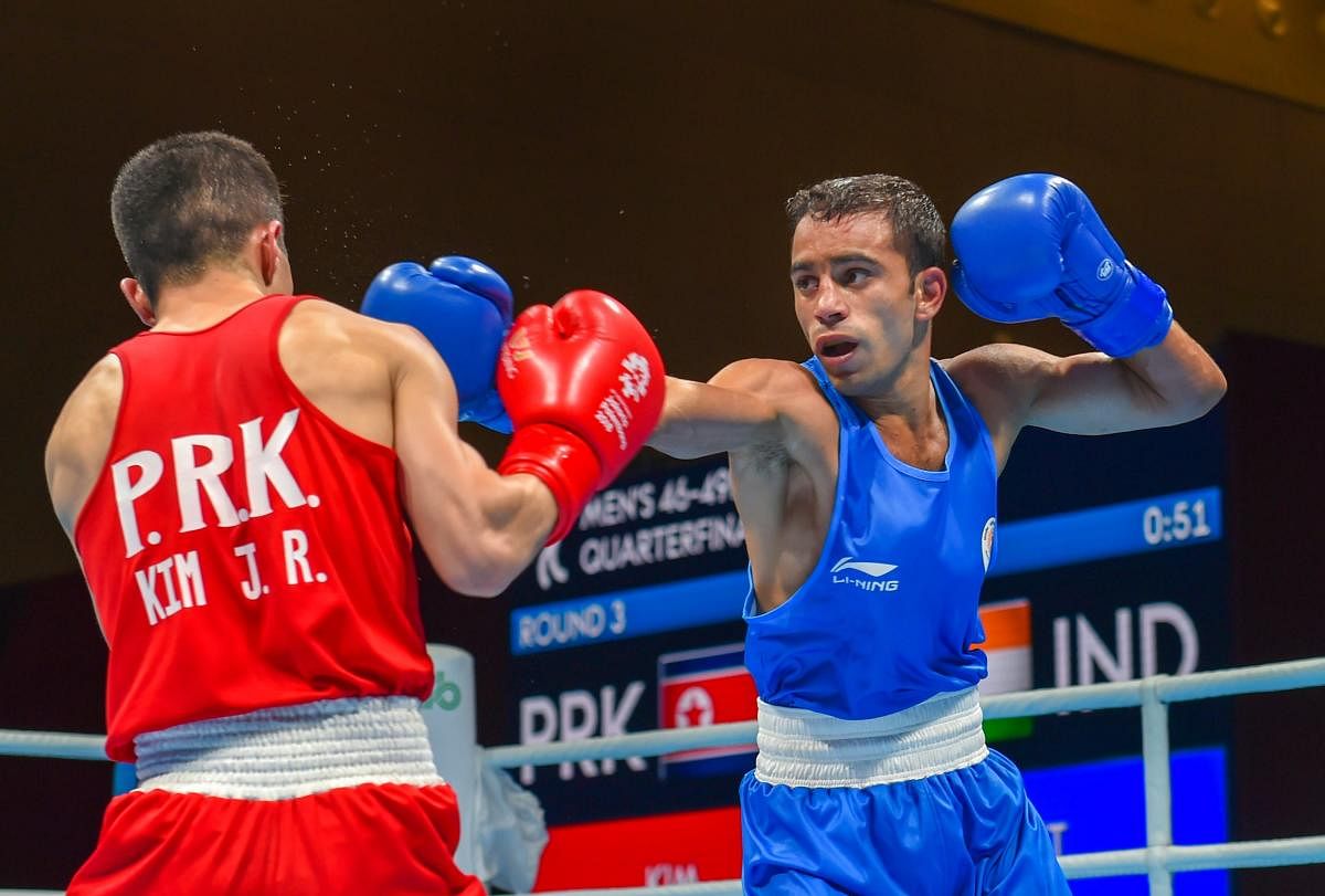 India's Amit Panghal (Blue) and PR Korea's Ryong Jong compete in the Men's Light Fly (46-49kg) Quarterfinal boxing event in the 18th Asian Games 2018 in Jakarta, Indonesia on Wednesday, Aug 29, 2018. PTI Photo