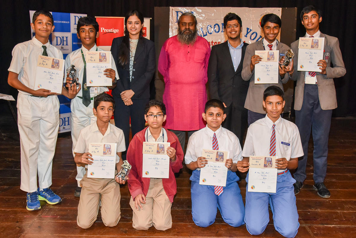 Winners of Senior division inter school quiz computation organised by Deccan Herald in Education (DHiE) at Bal Bhavan in Bengaluru on Thursday. Standing (from left) Shardul Parthasarathy and Hithysh L Kamth of Delhi Public School, Bengaluru South (First p