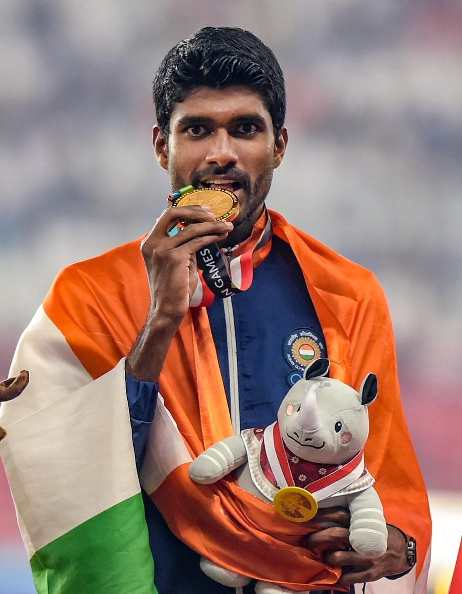 India’s Jinson Johnson celebrates his gold medal winning effort in the men’s 1500 metres. PTI