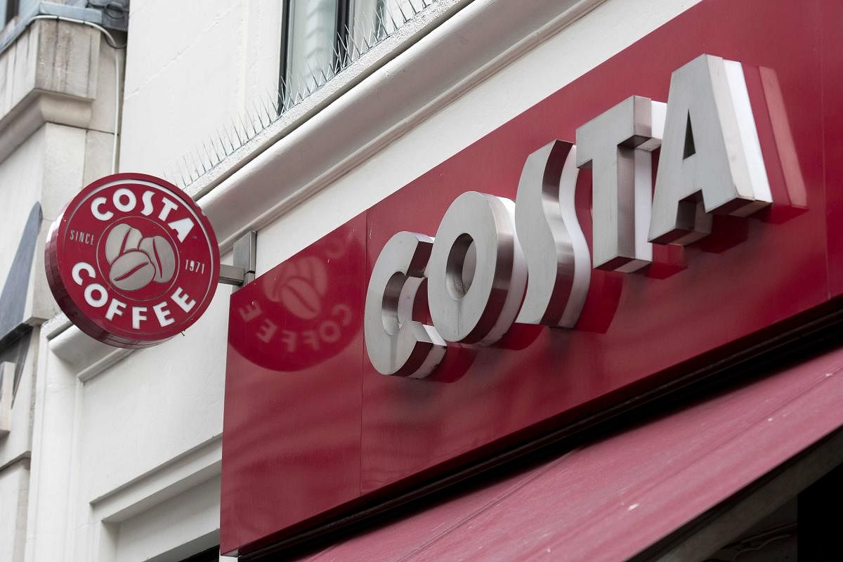 (FILES) In this file photo taken on November 15, 2017 the Costa coffee logo is pictured above a Costa coffee shop in London. AFP