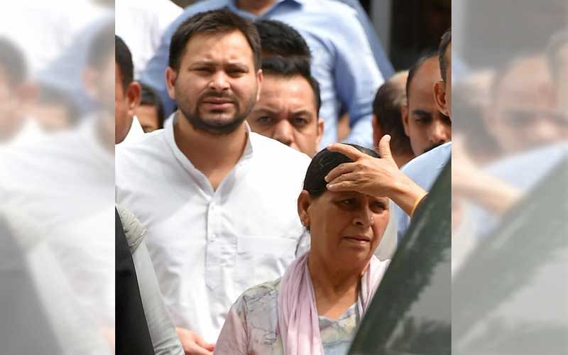 Former Bihar chief minister Rabri Devi with her son Tejashwi Prasad Yadav comes out of Patiala House court after appearing before a special court in the (IRCTC) tender scam case, in New Delhi on Friday, Aug 31, 2018. PTI photo