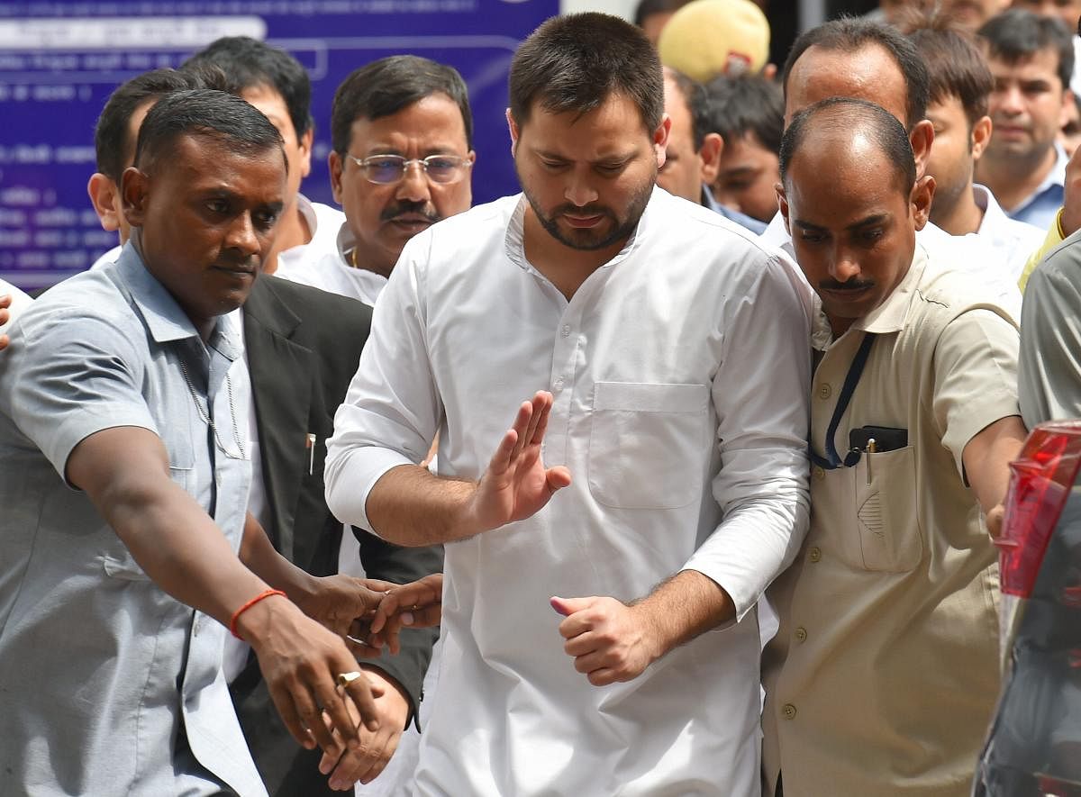 Former Bihar deputy chief minister Tejashwi Yadav comes out of the Patiala House court after appearing before a special court in the (IRCTC) tender scam case, in New Delhi on Friday. (PTI)