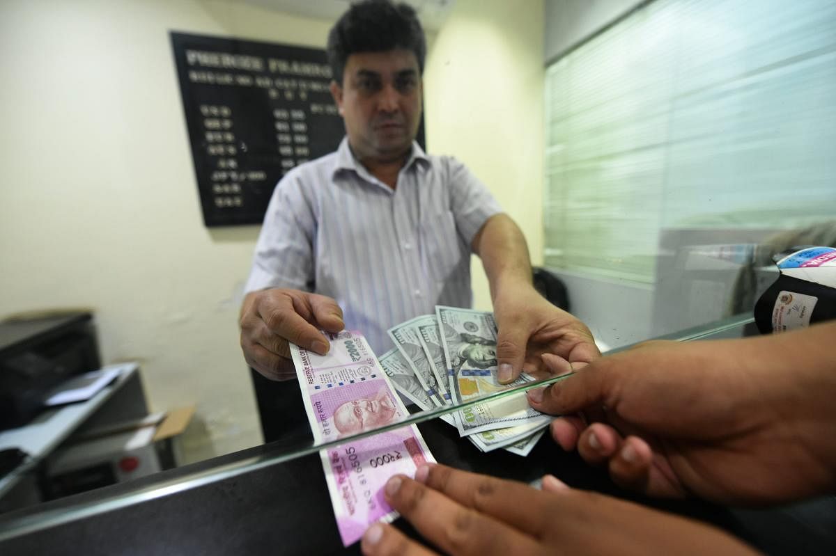 A customer exchanges currency at a forex bureau after the Rupee hit a new all-time low against US dollar in New Delhi, on Thursday, Aug. 30, 2018. (PTI Photo)