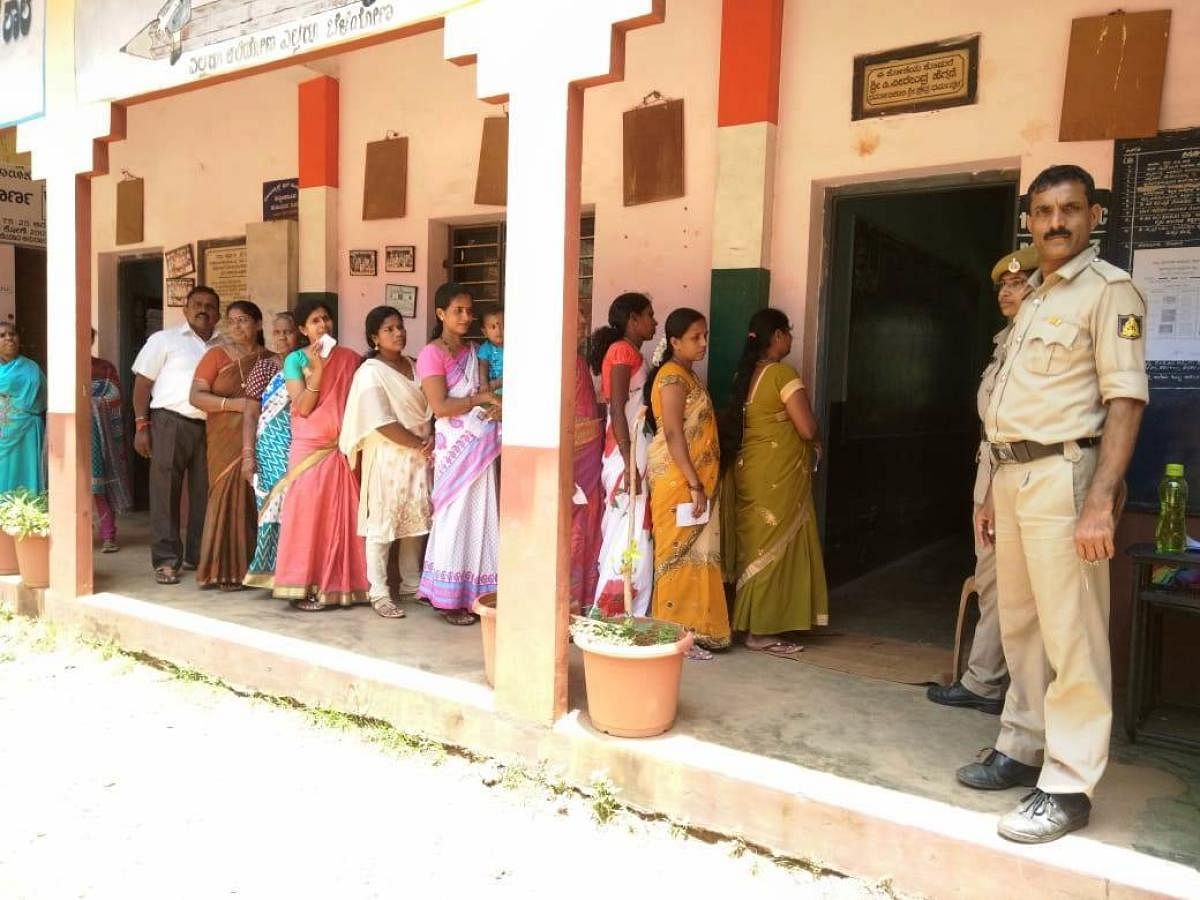 Voters wait for their turn to exercise their franchise in Kundapura TMC limits.