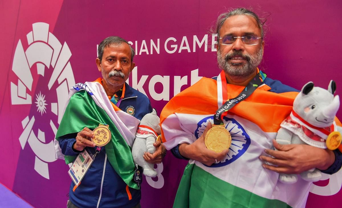 India's Pranab Bardhan and Shibhnath Sarkar with their gold medals after winning the bridge competition at the Asian Games in Jakarta on Saturday. PTI