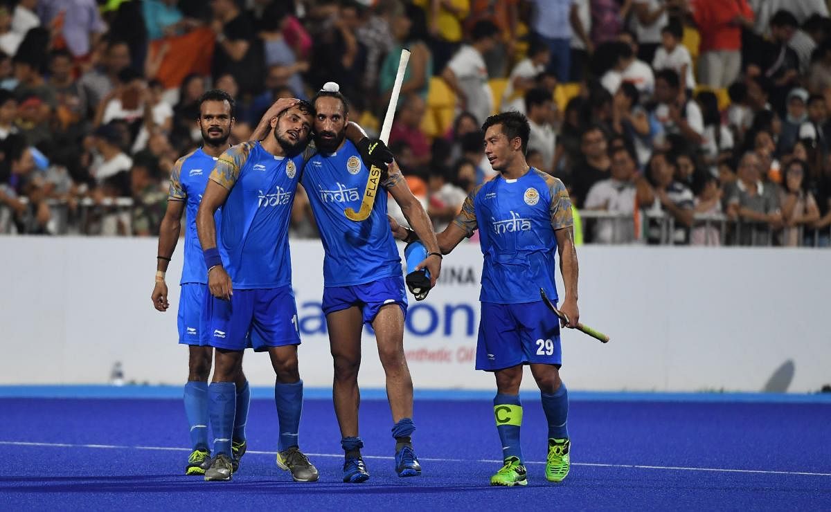 India's team members celebrate after winning the match against Pakistan during the men's hockey bronze medal match. AFP 
