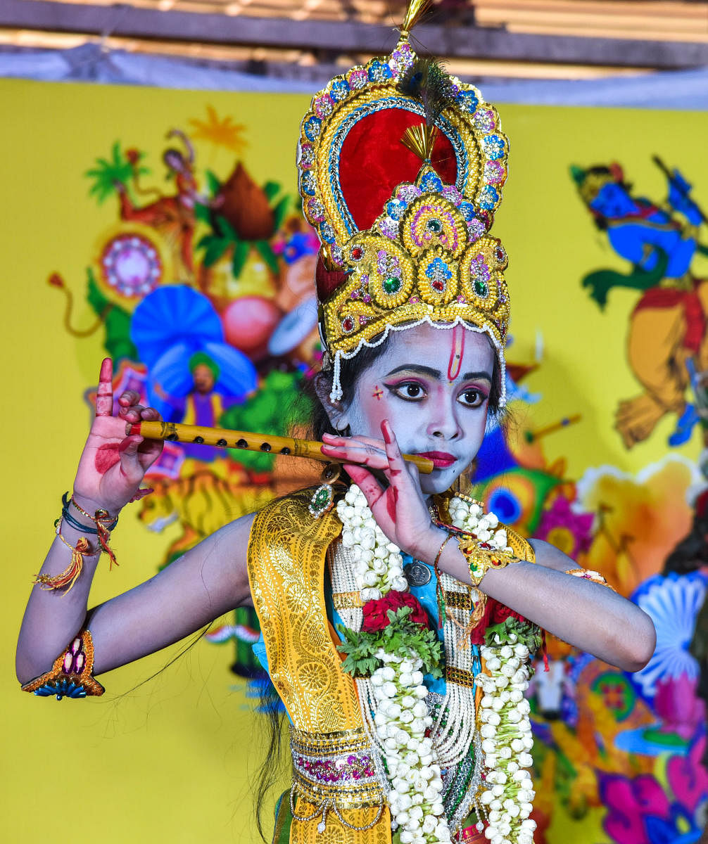 A child dressed up as Lord Krishna as part of the Janmashtami celebrations organised by Iskcon at Tripura Vasini, Palace Grounds, on Sunday. DH Photo/S K Dinesh
