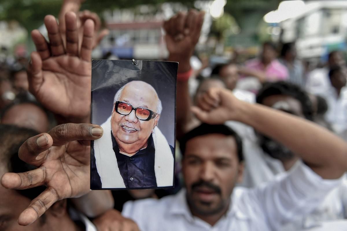 Dravida Munnetra Kazhagam (DMK) supporters gather outside the hospital, where DMK chief M Karunanidhi is being treated, in Chennai on Monday, July 30, 2018. (PTI Photo)