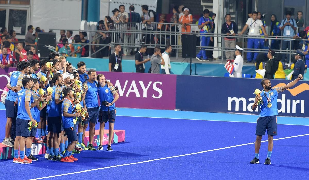 Indian men's hockey team captain Sreejesh takes selfie with their bronze medals during the medal ceremony at the 18th Asian Games 2018, in Jakarta. (PTI Photo)