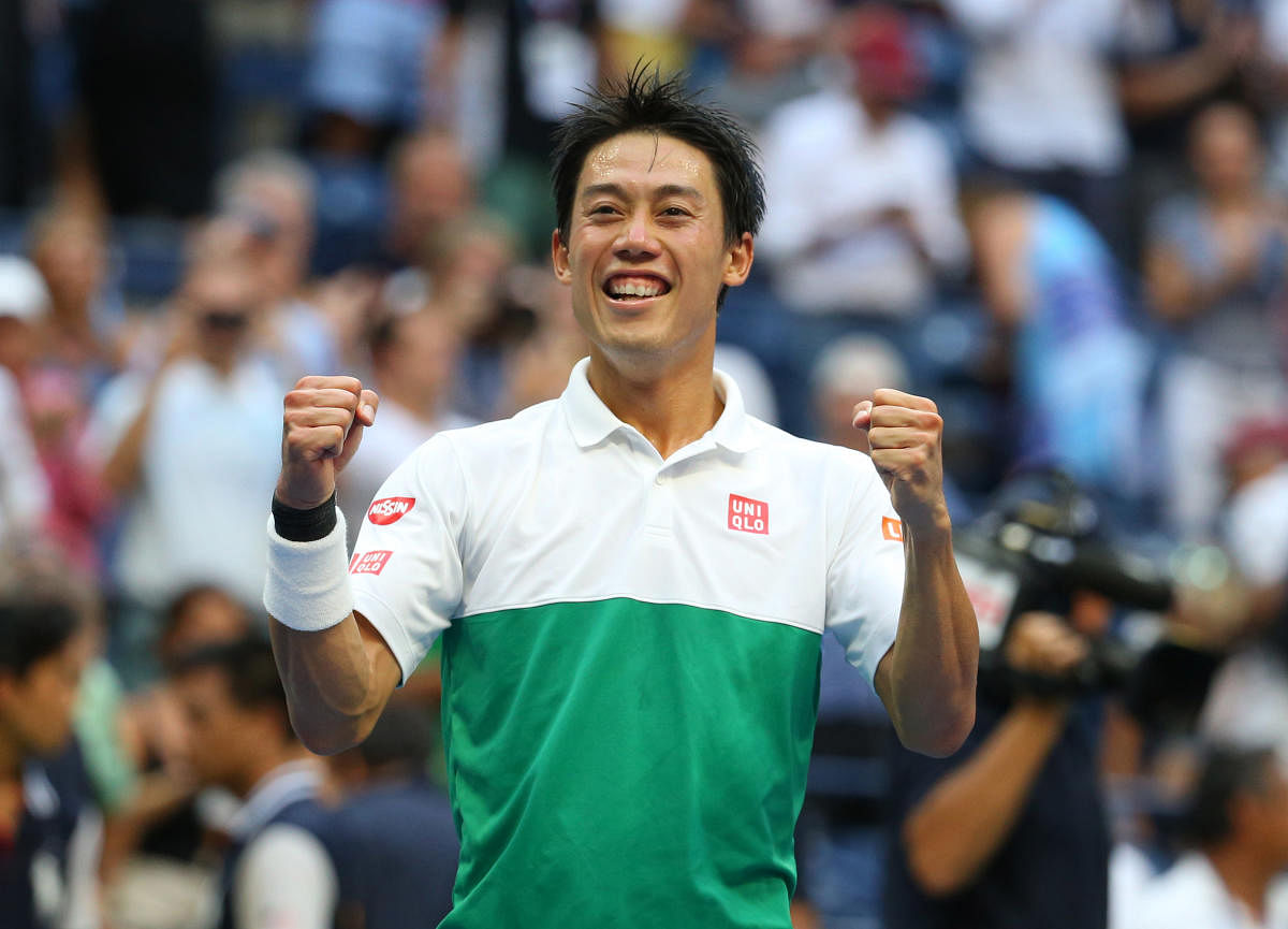 I DID IT: Kei Nishikori of Japan celebrates after winning a gruelling five-set men's quarterfinal tie against Marin Cilic of Croatia. 