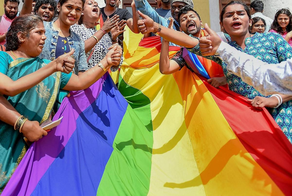 LGBTQ community people, with a rainbow flag, celebrate the Supreme Court verdict which decriminalises consensual gay sex, in Bengaluru, Thursday, Sept 6, 2018. (PTI Photo)