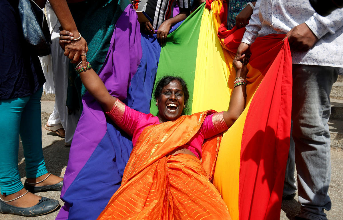 An activist of lesbian, gay, bisexual and transgender (LGBT) community celebrates after the Supreme Court's verdict of decriminalizing gay sex. REUTERS