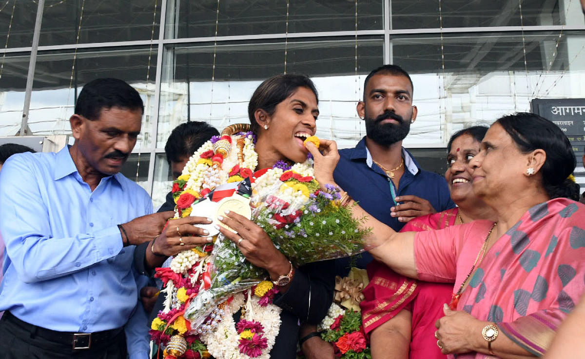 Sprinter M R Poovamma, who arrived at Mangaluru International Airport on Thursday, was given a grand welcome.