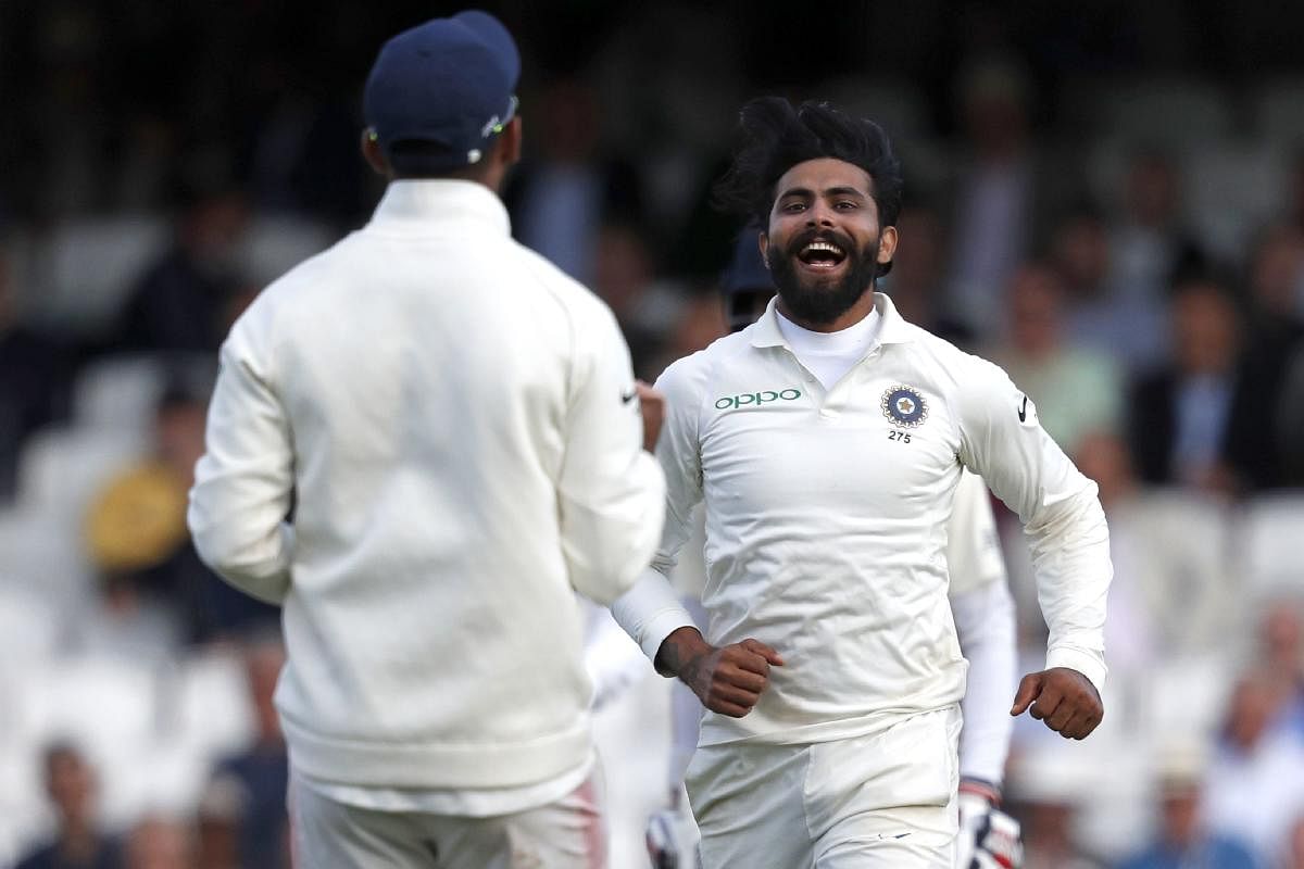 India's Ravindra Jadeja (R) celebrates after taking the wicket of England's Ben Stokes during play on the first day of the fifth Test cricket match between England and India at The Oval in London. AFP photo