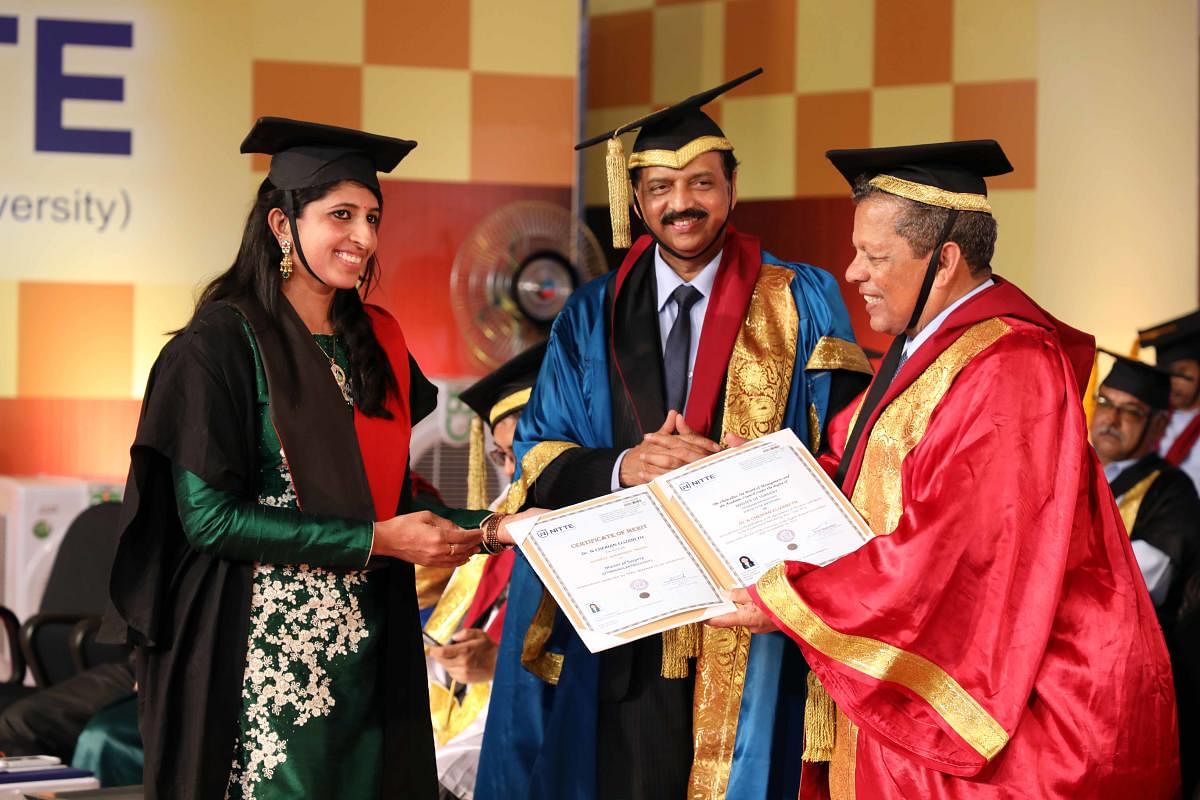 A student receives her degree from Nitte Deemed to be University Chancellor N Vinay Hegde during the convocation at Deralakatte on Saturday.