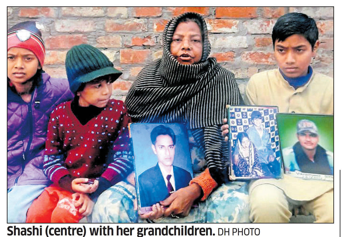 Shashi Devi of Maqbolpura village in Amritsar district, who lost her three sons to drugs, with her grandchildren. dh photo
