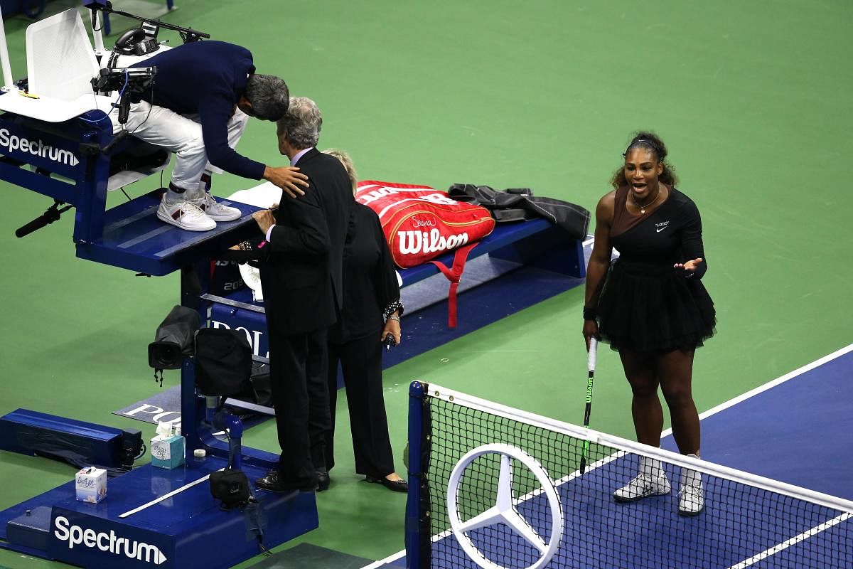 UNSAVOURY: Serena Williams fumes as chair umpire Carlos Ramos has conversation with US Open offcials during women's final on Saturday. AFP