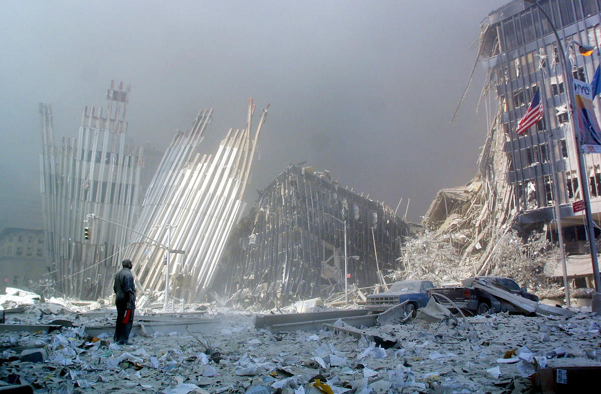 In this file photo taken on September 11, 2001, a man stands in the rubble, and calls out asking if anyone needs help, after the collapse of the first World Trade Center Tower in New York. - Seventeen years later, more than 1,100 victims of the hijacked plane attacks on the World Trade Center have yet to be identified. (AFP File Photo)