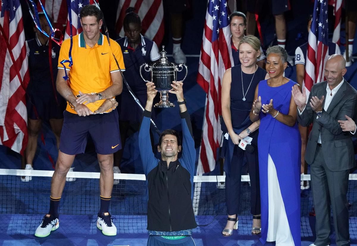 Novak Djokovic of Serbia celebrates his victory over Juan Martin del Potro of Argentina (L) after their 2018 US Open men's singles final match on September 9, 2018 in New York. (AFP Photo)