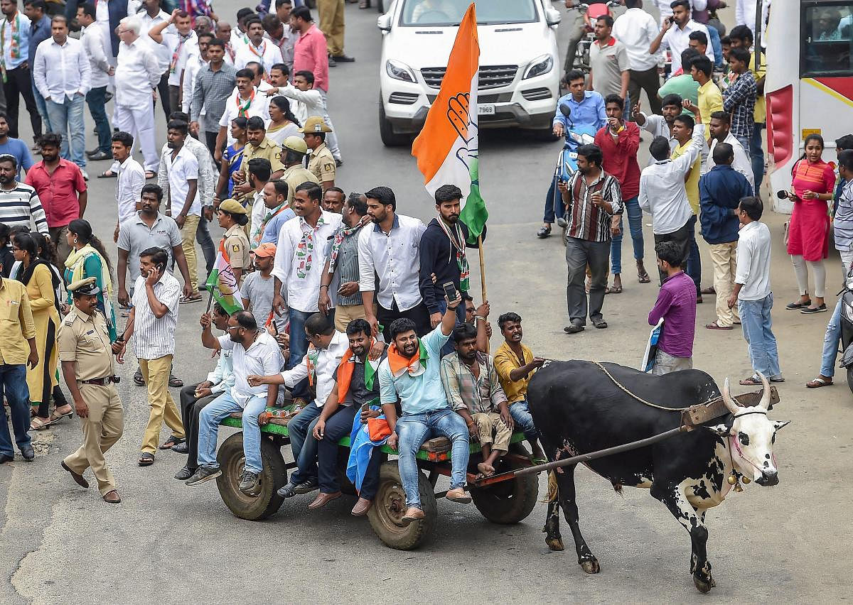 Congress party workers ride on a bullock-cart during the 'Bharat Bandh' called against fuel price hike and devaluation of the rupee, in Bengaluru, Monday, Sept 10, 2018. PTI Photo