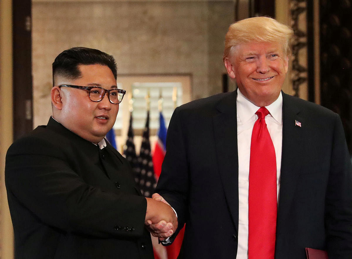 U.S. President Donald Trump and North Korea's leader Kim Jong Un shake hands after signing documents during a summit at the Capella Hotel on the resort island of Sentosa, Singapore, June 12, 2018. REUTERS/Jonathan Ernst/File Photo