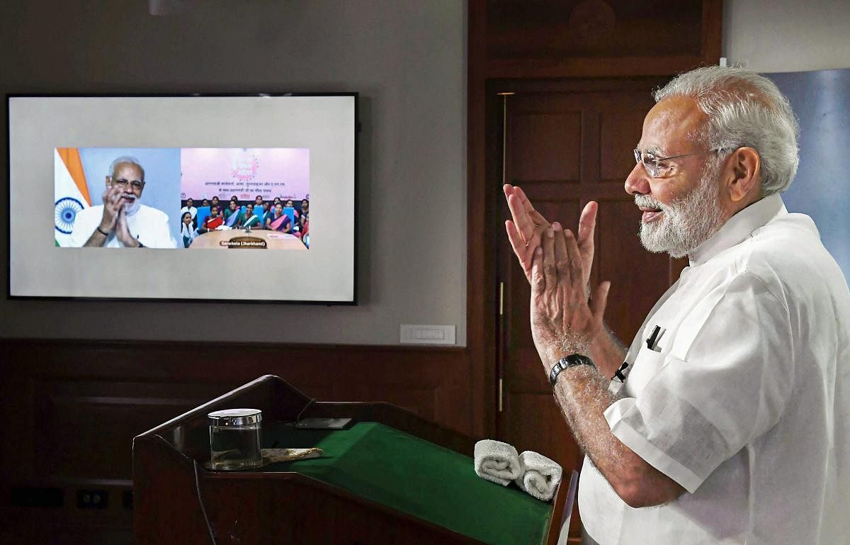 Prime Minister Narendra Modi interacts with ASHA, Anganwadi and ANM workers from all over the country through video conference, in New Delhi on Tuesday. (PIB Photo via PTI)