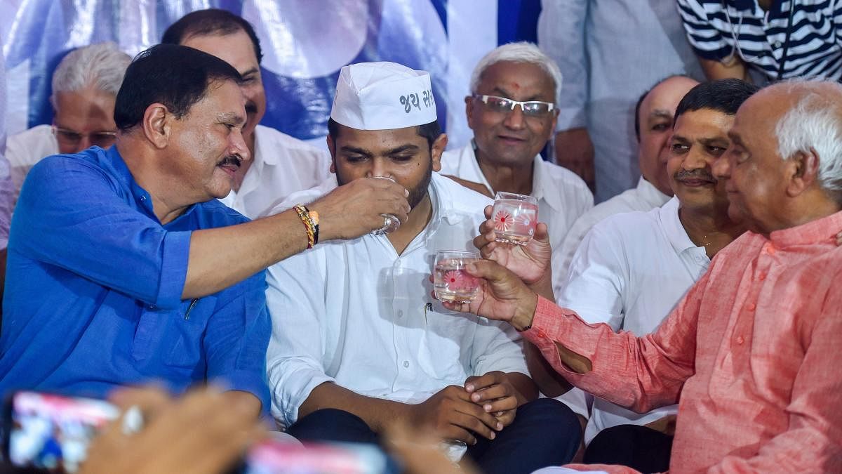 Patidar leaders C K Patel Patidar, Naresh Patel and Pralhad Patel offer coconut water to Patidar Anamat Andolan Samiti (PAAS) leader Hardik Patel to break his 19-day long indefinite hunger strike, in Ahmedabad, on Wednesday. PTI