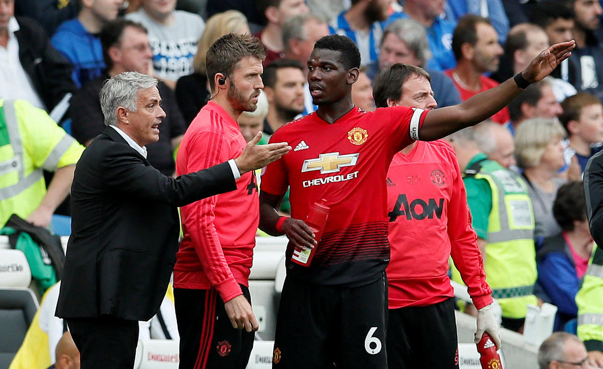 Manchester United manager Jose Mourinho speaks with Paul Pogba during the EPL game against Brighton. (Reuters File Pic)