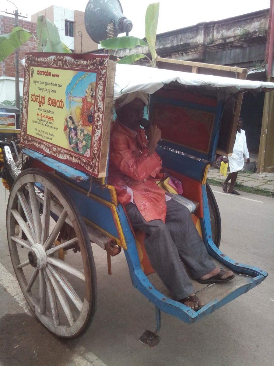 Town crier Mike Chandru announcing the staging of a drama in Mysuru.