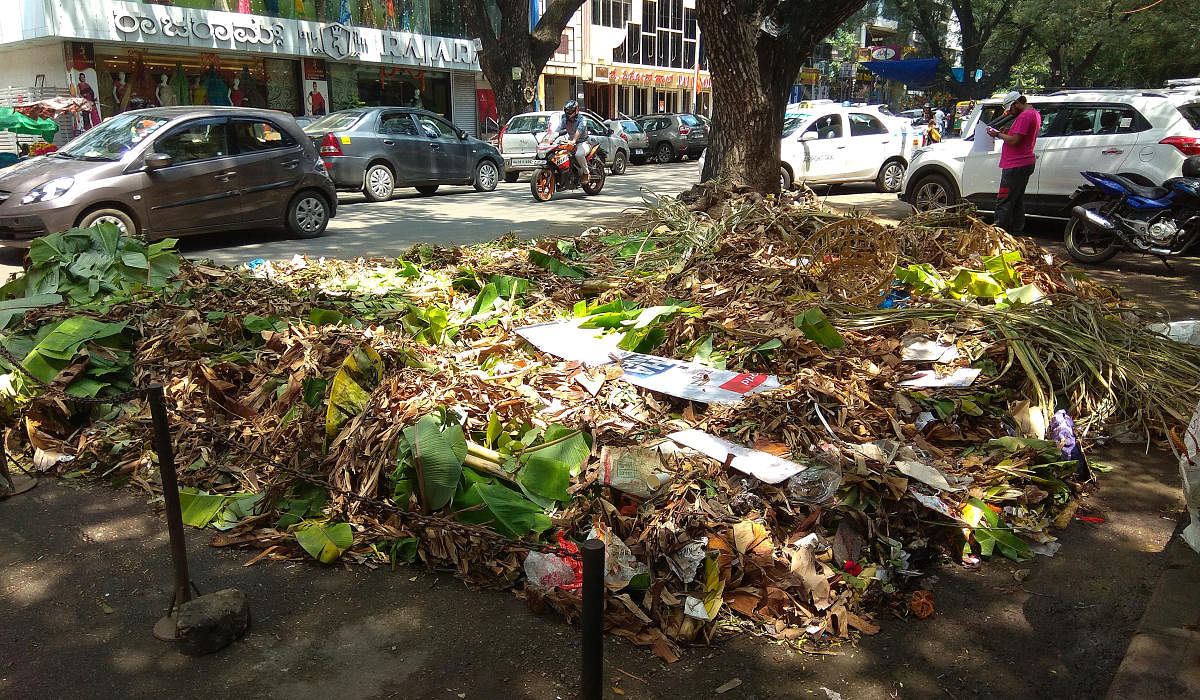 Plantain leaves and waste from the Ganesha festival left uncleared in Gandhi Bazaar on Friday. (DH Photo/Srikanta Sharma R)