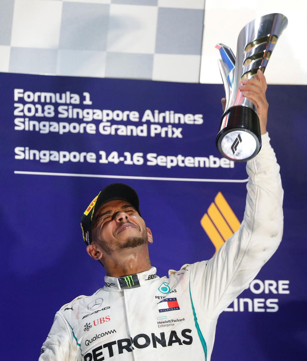 TOO GOOD: Mercedes' Lewis Hamilton celebrates on the podium after winning the Singapore GP on Sunday. REUTERS