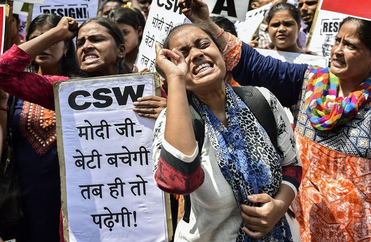 Protestors raise slogans during a protest against the alleged gang rape of a 19-year-old CBSE topper in Rewari, outside Haryana Bhawan in New Delhi. PTI Photo 