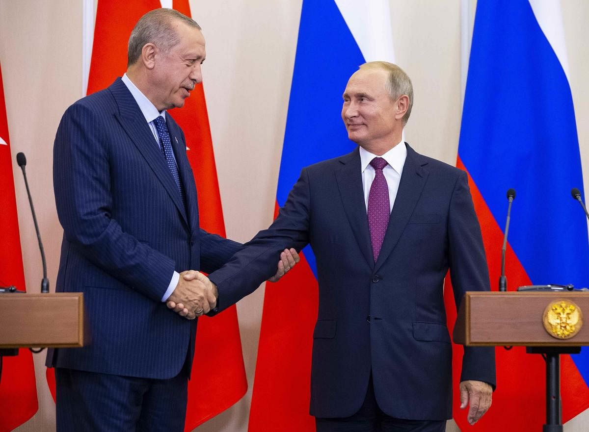 Turkish president Tayyip Erdogan and his Russian counterpart Vladimir Putin shake hands during a news conference following their talks in Sochi, Russia on September 17, 2018. Reuters