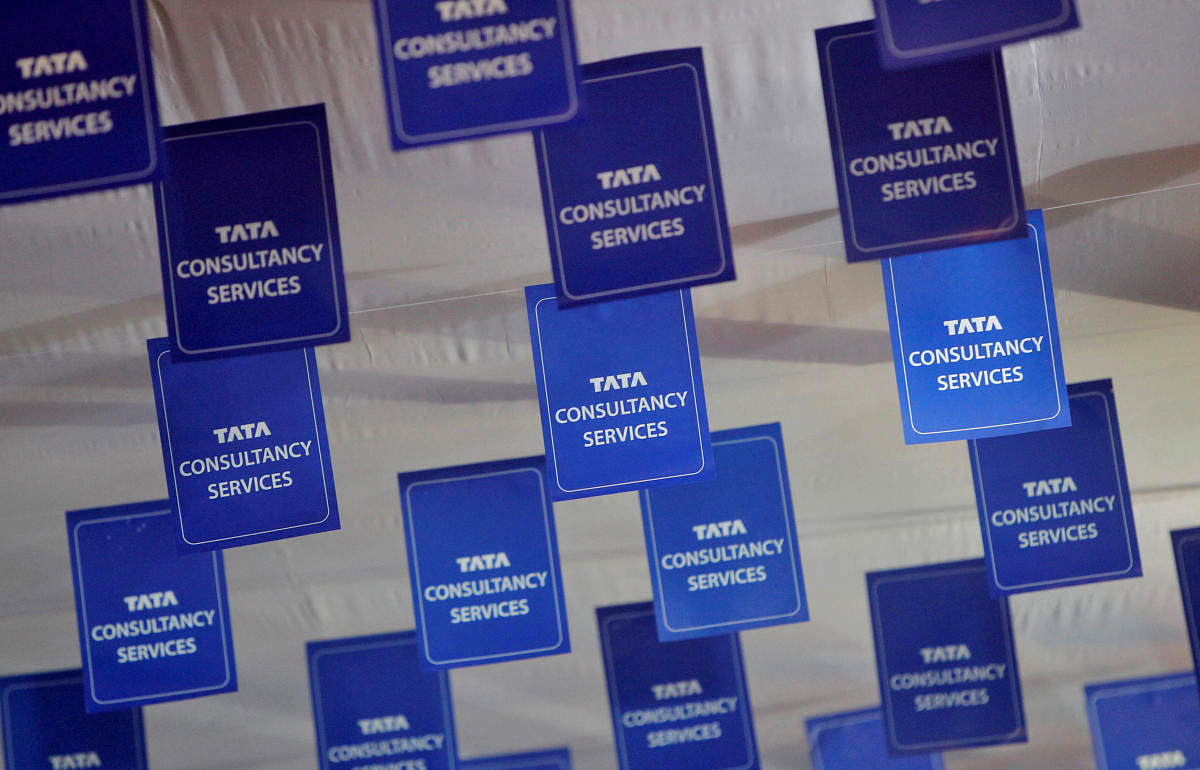 FILE PHOTO: Logos of Tata Consultancy Services (TCS) are displayed at the venue of the annual general meeting of the software services provider in Mumbai.