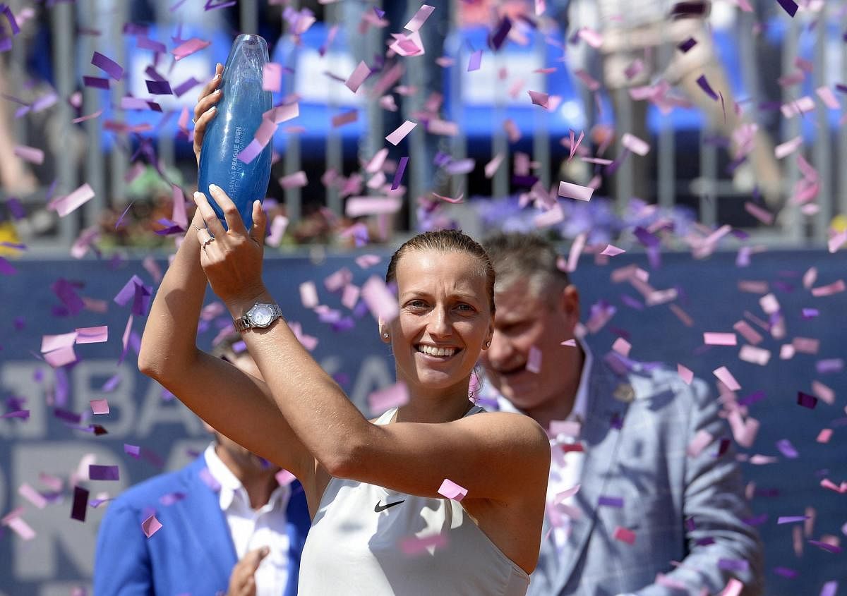 Petra Kvitova celebrates with the trophy after defeating Mihaela Buzarnescu of Romania in the Prague Open final on Saturday. AP-PTI